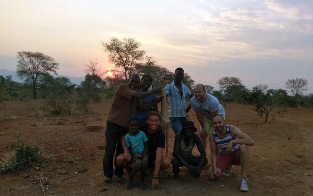 This is a sunset in Malawi and a picture with a handmade wooden giraffe.